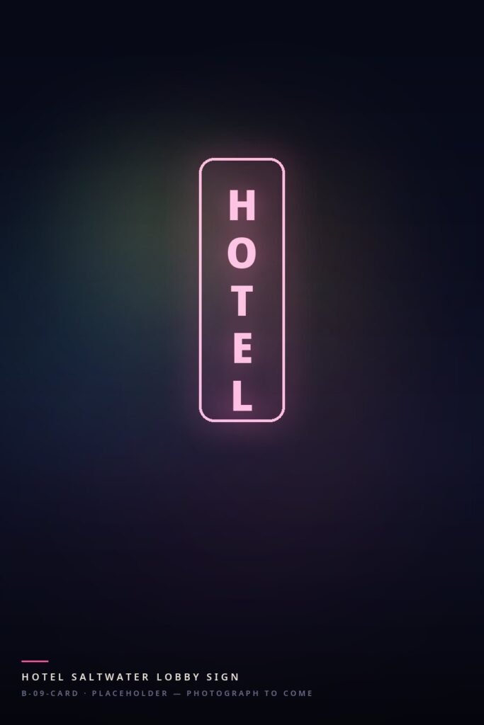 A tall hotel sign in pink neon