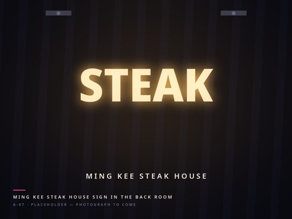 Ming Kee Steak House sign lit in the back room